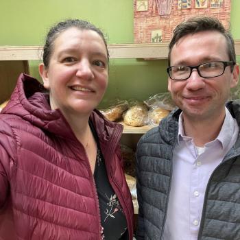 Two LSV attorneys smile for a photo from inside the foodshelf